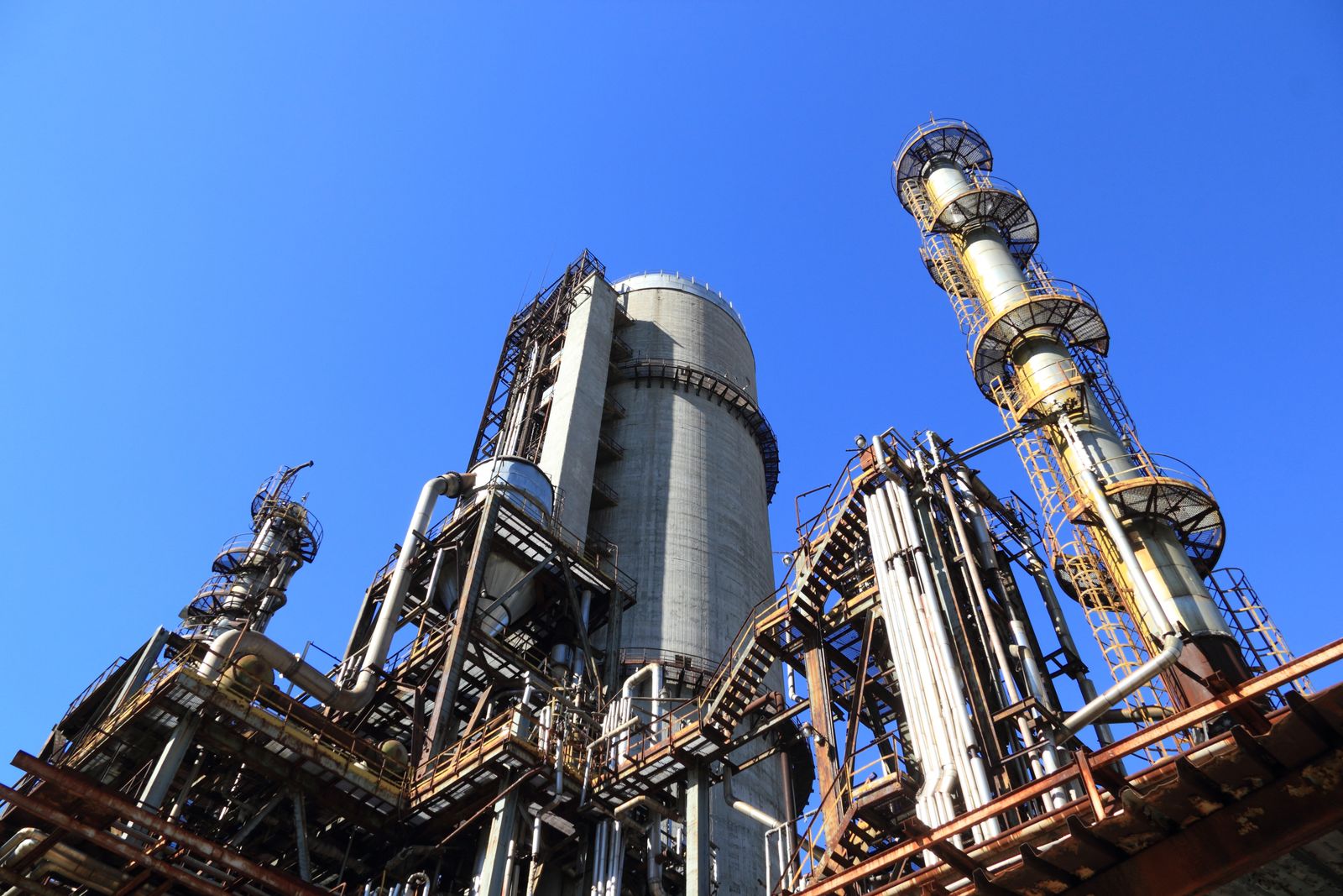 Process towers and pipework at an industrial plant