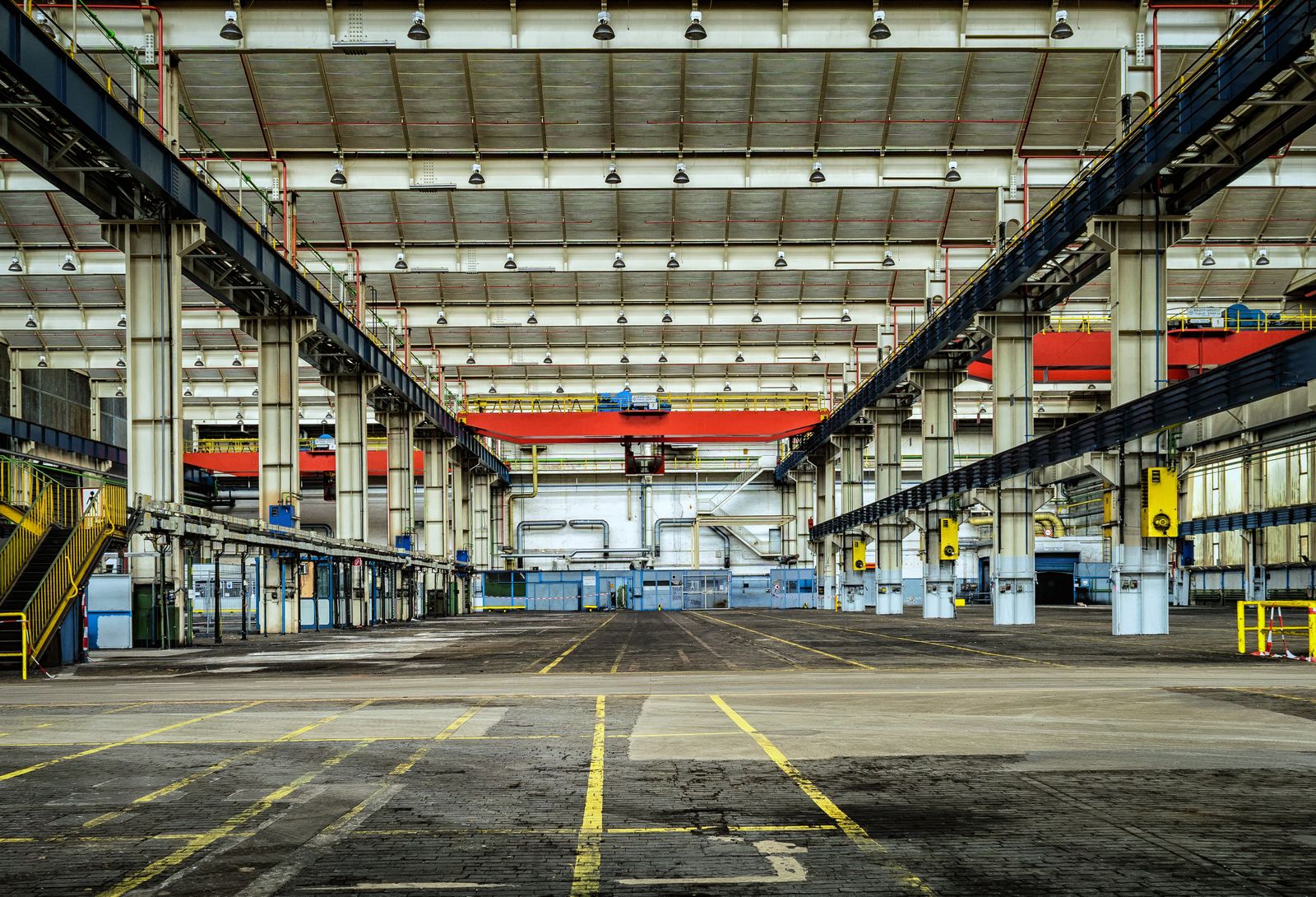 A large industrial hall with overhead cranes