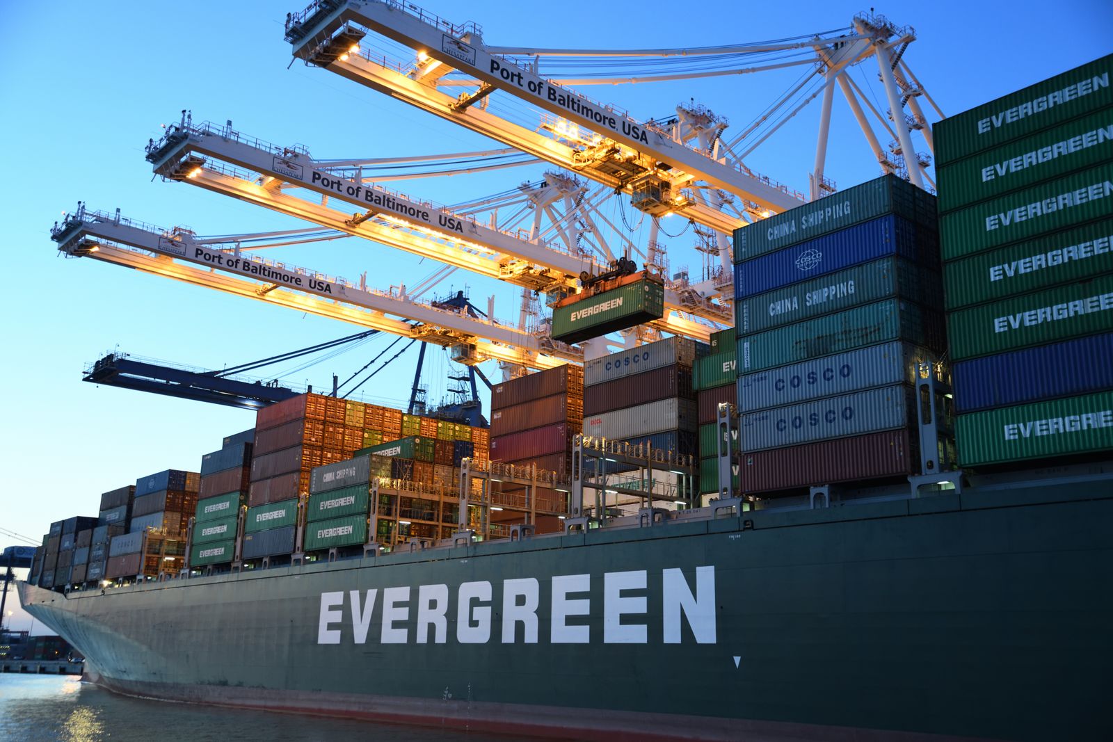 A container ship alongside port cranes