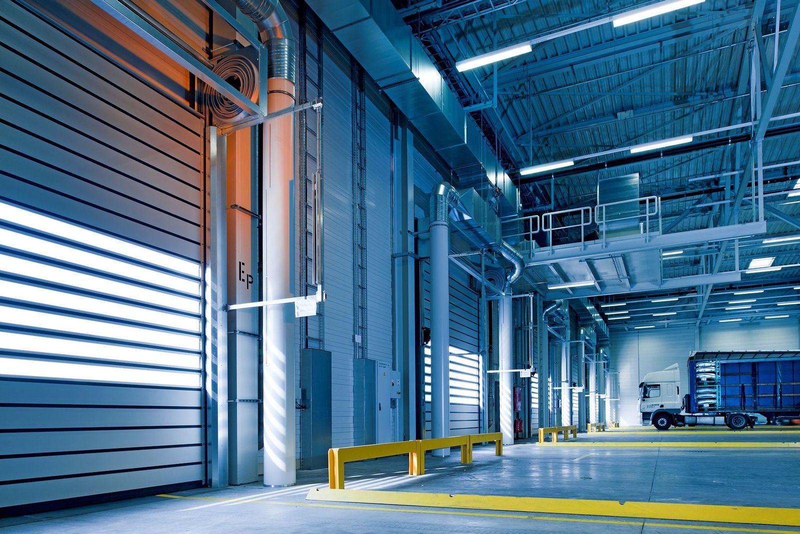 A loading bay with a goods vehicle inside an industrial building