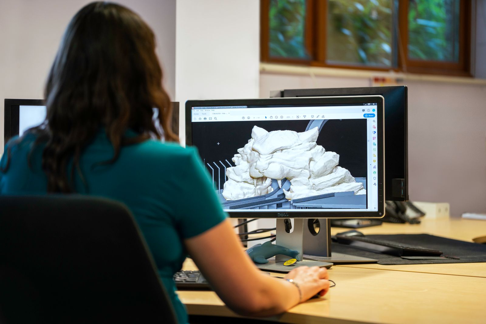 A person reviewing a site model on a screen