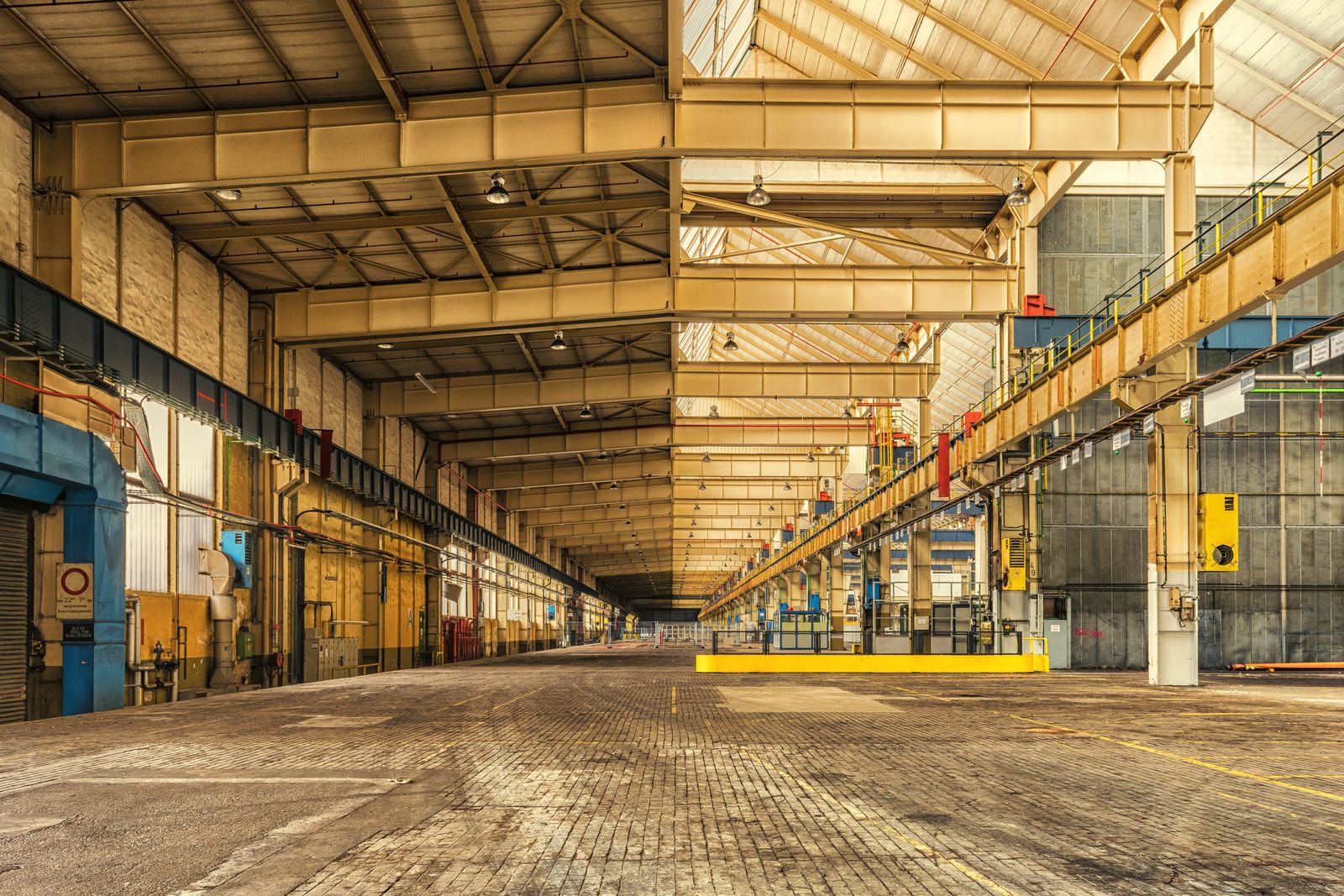 A long industrial workshop with overhead steelwork