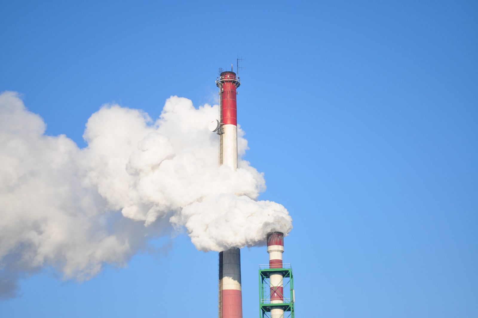 Industrial chimneys against a clear sky